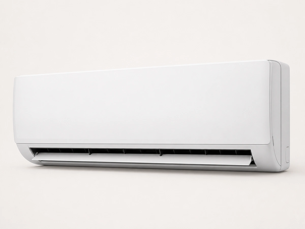 Wall-mounted split indoor unit isolated on a plain studio background
